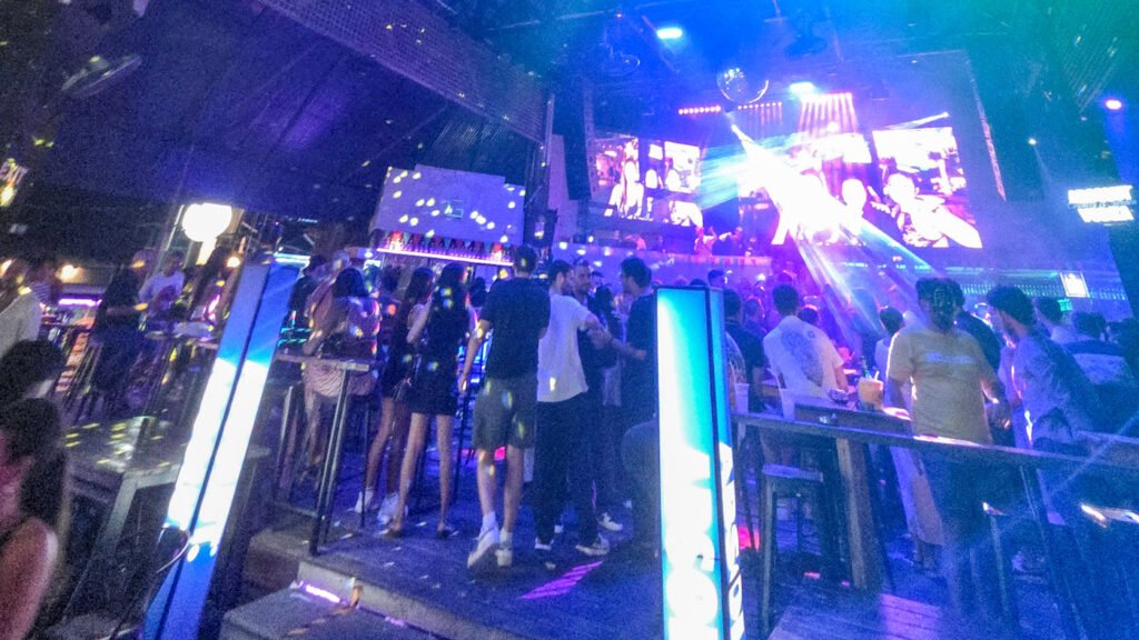 Nightclub entrance in Chaweng, Koh Samui with disco lights and crowds