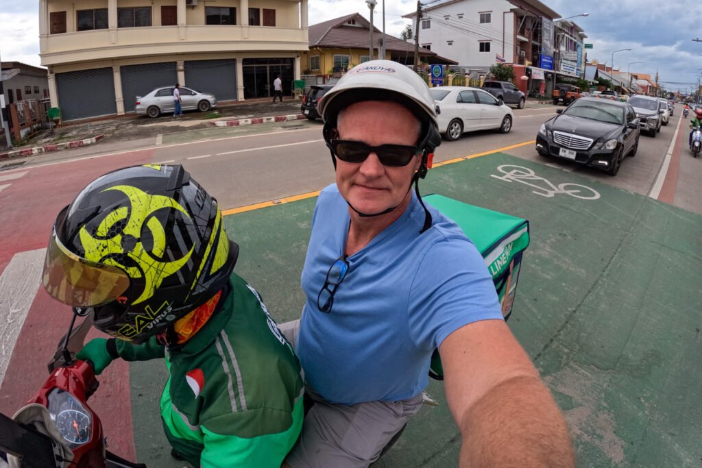 The author sitting on a Grab motorcycle behind the drive filming himself