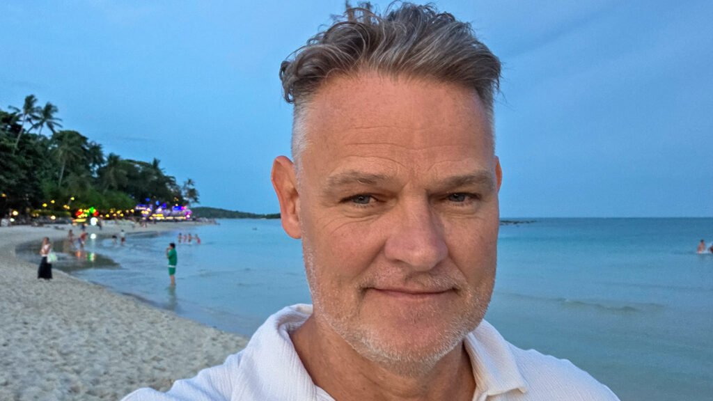 Author standing on Chaweng Beach in Koh Samui reflecting on nomad life after 50