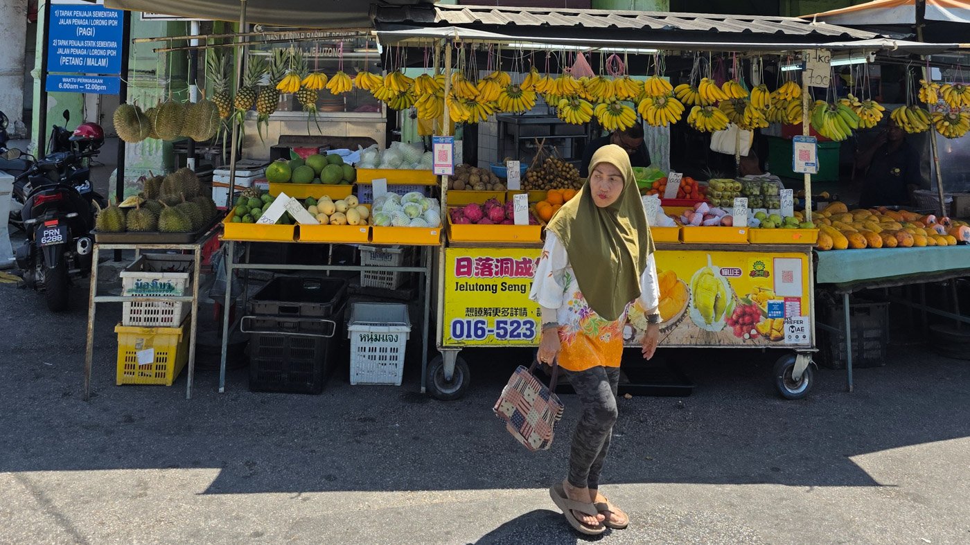 Daily life outside a local grocery store in Penang, Malaysia