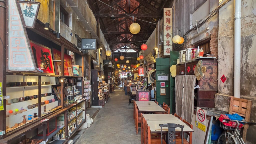 Hidden market hall in George Town, Penang with artifacts and Chinese signs