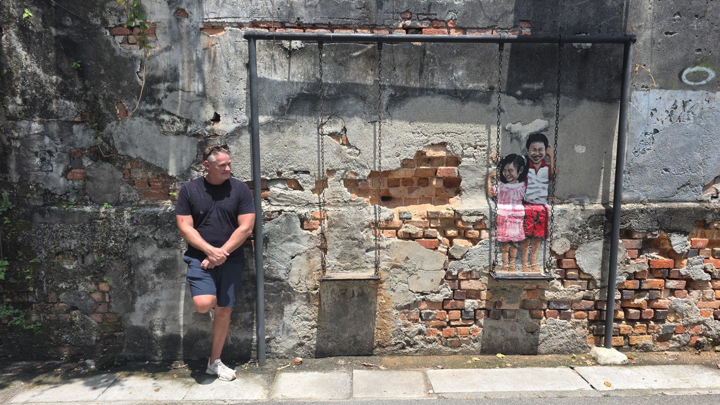 Martin in George Town observing tourists at a popular street art attraction in Penang