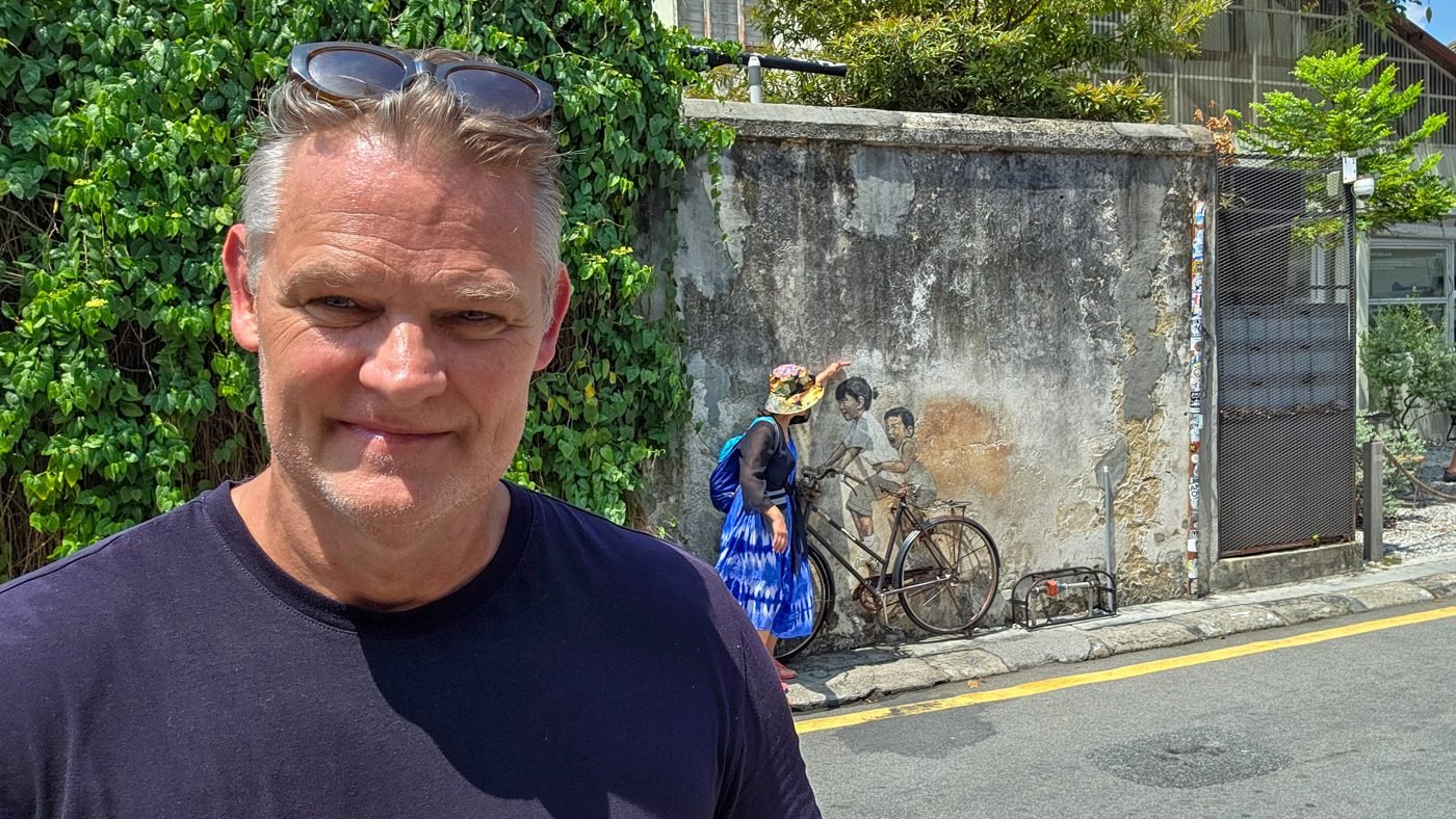 Martin standing near the famous bicycle mural in George Town, Penang