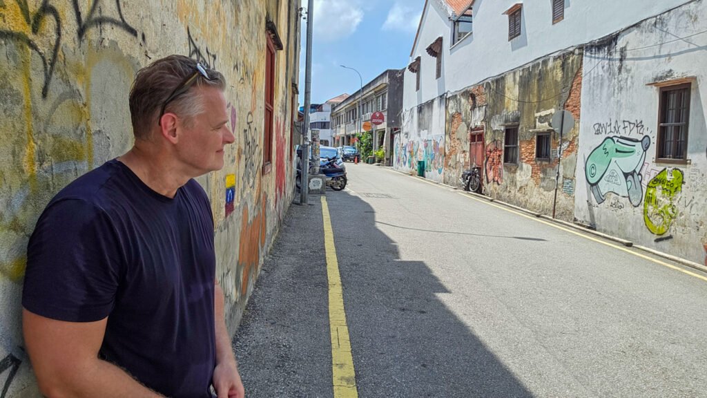 Martin standing on a quiet street in Penang, Malaysia