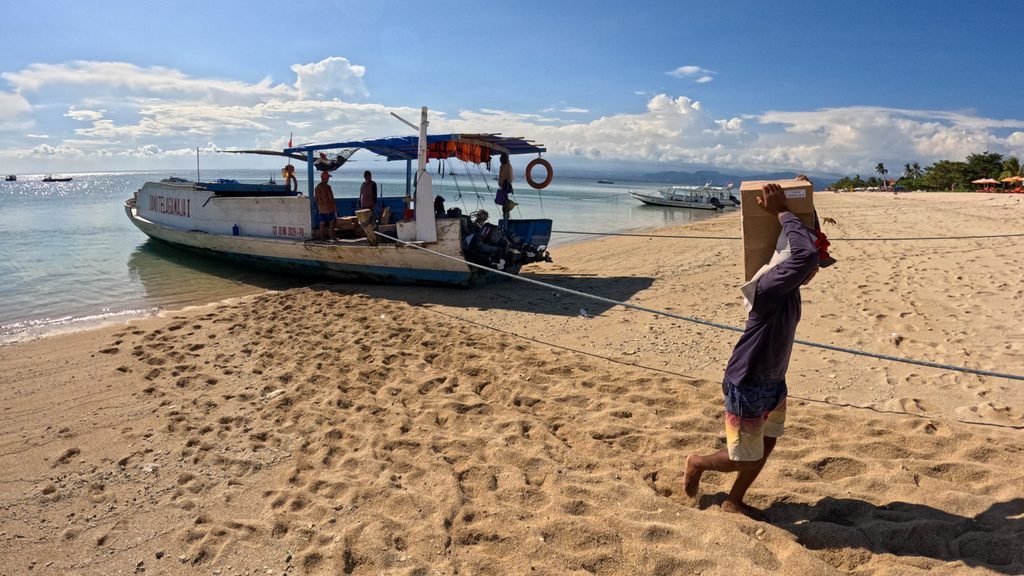 Freight boat unloading supplies on the beach in Jungut Batu, Nusa Lembongan