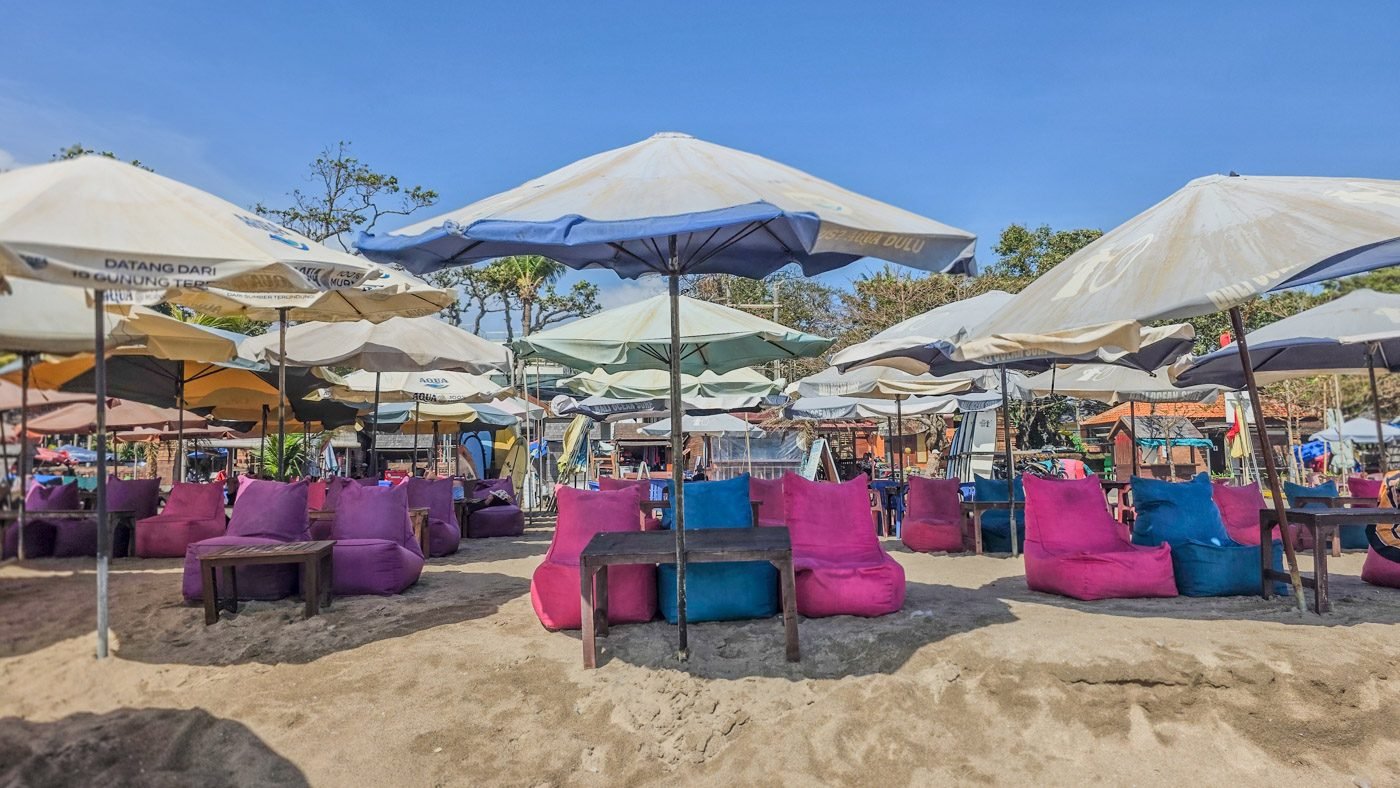 Rows of umbrellas and sunbeds on Seminyak Beach before visitors arrive.
