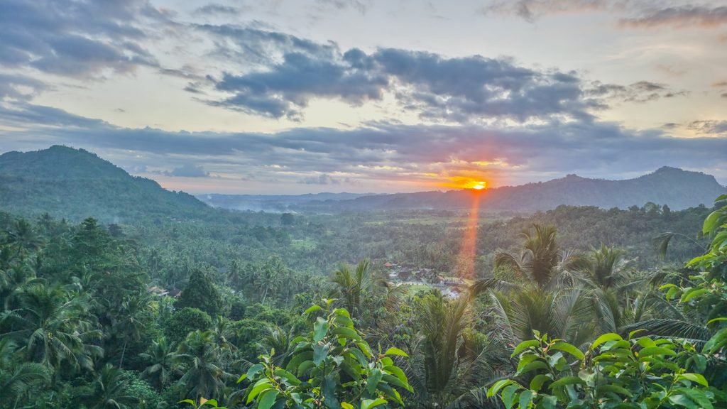 Sunset over the Sidemen valley with Mount Agung visible in the distance.