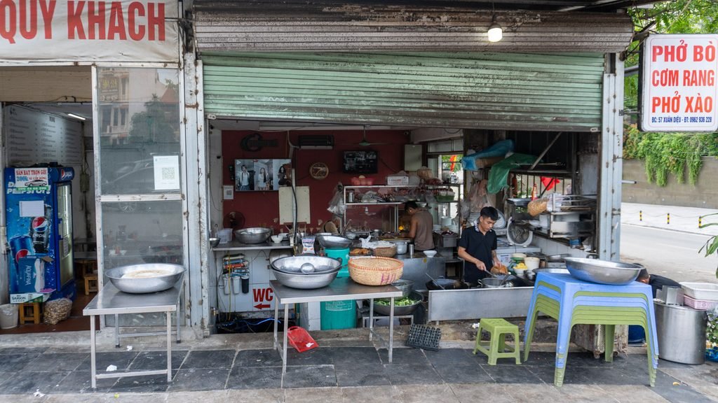 A cook preparing food outside a neighborhood street restaurant in Hanoi, Vietnam.