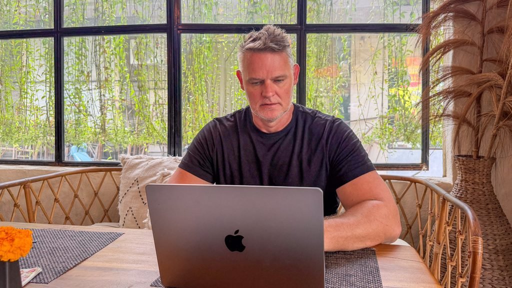 Martin working on a laptop in a café in Bali.