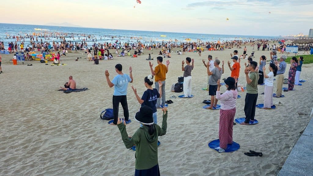 People exercising together on My Khe Beach in Da Nang, Vietnam