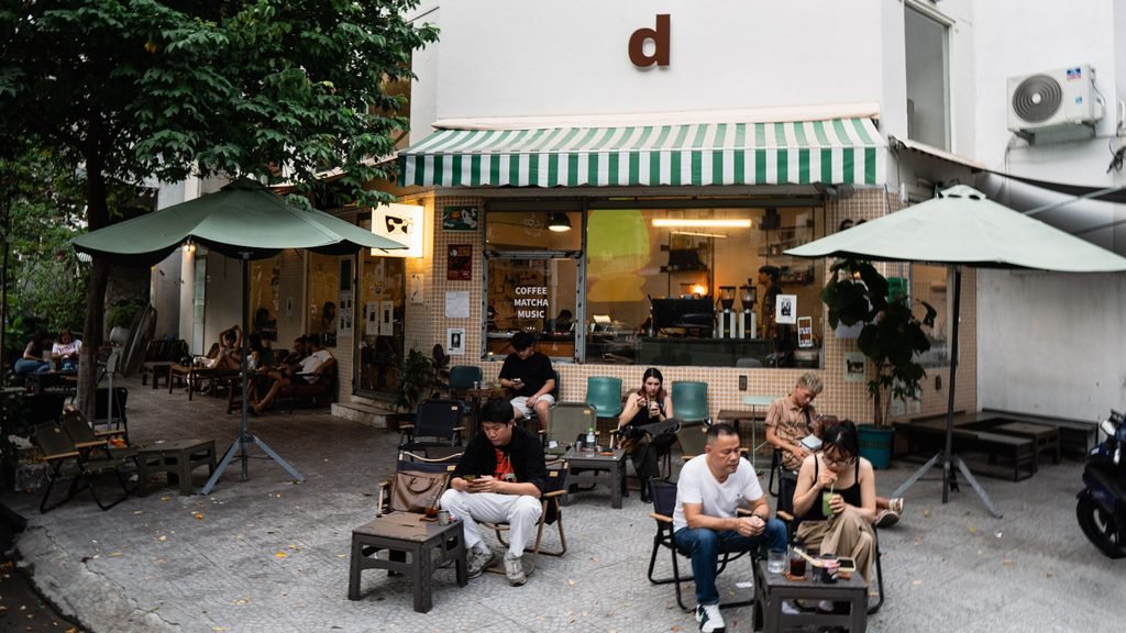 People relaxing outside a neighborhood coffee shop in Da Nang, Vietnam.